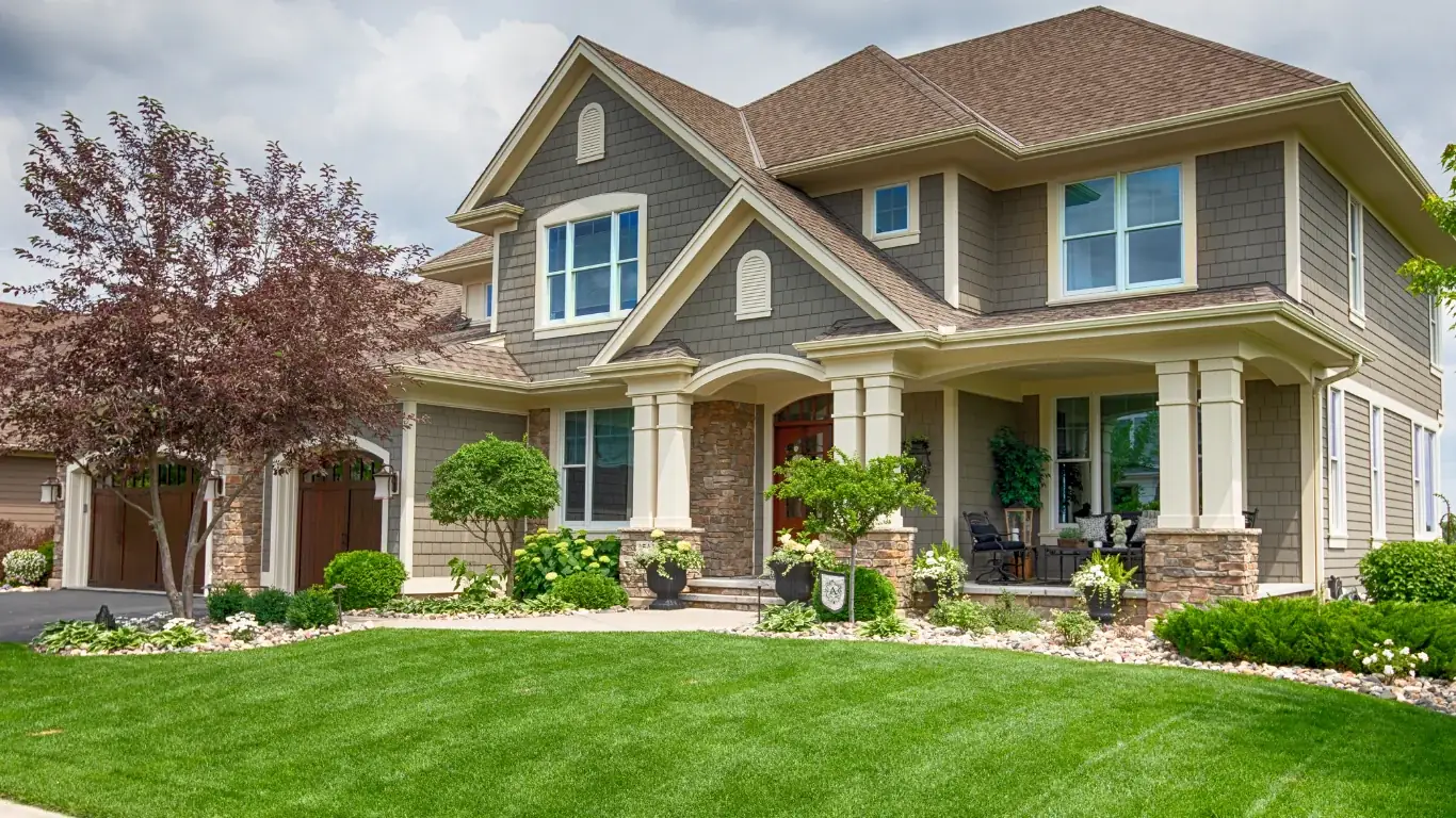 A green lawn and landscaped beds surrounding a Virginia home